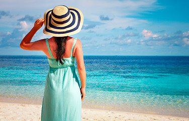 Image showing Girl walking along a tropical beach in the Maldives.