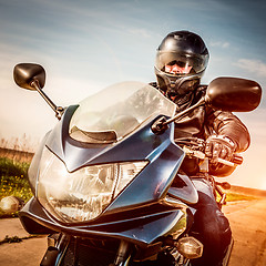 Image showing Biker racing on the road