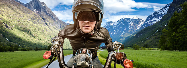 Image showing Biker racing on the road