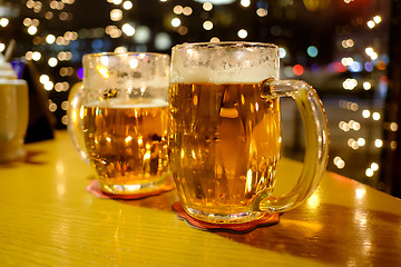 Image showing Two cups of beer in a pub