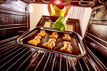 Image showing Baking Gingerbread man in the oven