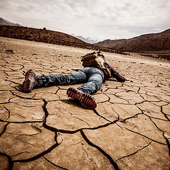 Image showing person lays on the dried ground