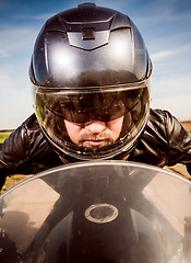 Image showing Biker racing on the road