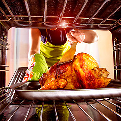 Image showing Cooking chicken in the oven at home.