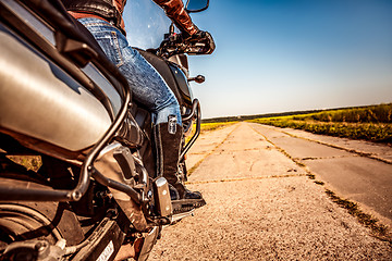 Image showing Biker girl riding on a motorcycle