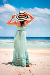 Image showing Girl walking along a tropical beach in the Maldives.