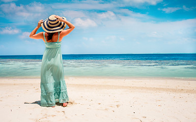 Image showing Girl walking along a tropical beach in the Maldives.