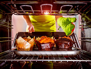 Image showing Baking muffins in the oven