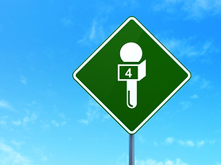 Image showing News concept: Microphone on road sign background