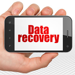 Image showing Information concept: Hand Holding Smartphone with Data Recovery on display