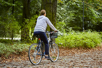 Image showing Woman on the bicycle in park