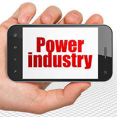 Image showing Industry concept: Hand Holding Smartphone with Power Industry on display