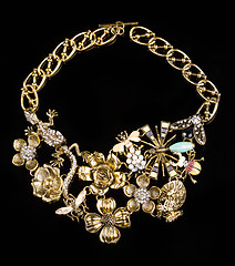 Image showing luxury necklace of plastic flowers on black stand