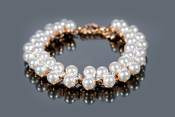 Image showing bracelet of pearls on a gray background