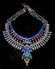 Image showing metal necklace with red and blue stones