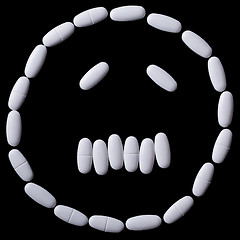 Image showing White pills on the black