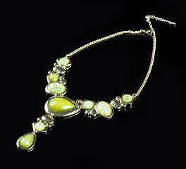 Image showing luxury green necklace on black stand