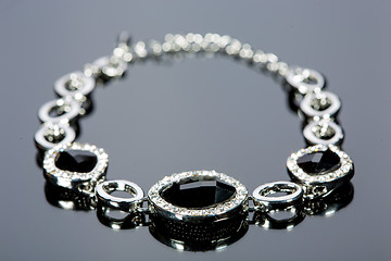 Image showing beautiful bracelet on gray background. 