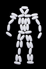 Image showing White pills on the black