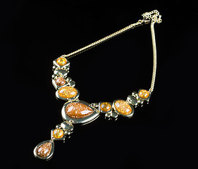 Image showing luxury yellow necklace on black stand