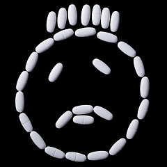 Image showing White pills on the black