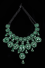 Image showing luxury green necklace on black stand