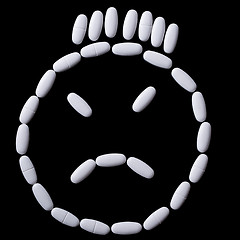 Image showing White pills on the black