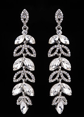 Image showing earrings with jewels on the black