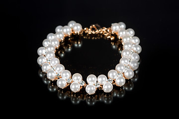 Image showing bracelet of pearls on a black background
