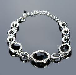 Image showing beautiful bracelet on gray background. 