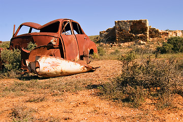 Image showing an old rusting car and ruins in the desert