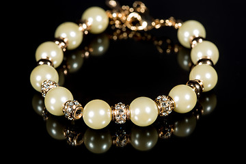 Image showing bracelet of pearls on a black background