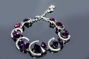 Image showing beautiful bracelet on gray background. 