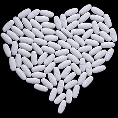 Image showing heart of white oblong tablets 