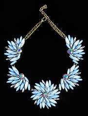 Image showing luxury necklace of plastic flowers on black stand