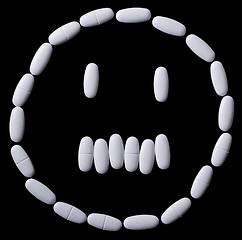 Image showing White pills on the black