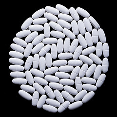 Image showing White pills on the black