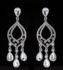 Image showing earrings with jewels on the black