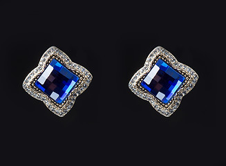 Image showing earring with colorful blue gems on black background