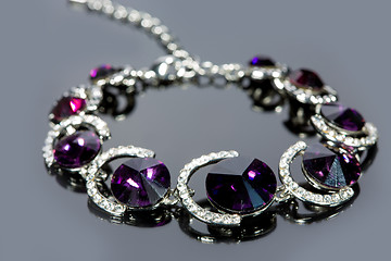 Image showing beautiful bracelet on gray background. 