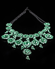 Image showing luxury green necklace on black stand