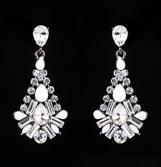 Image showing earrings with jewels on the black