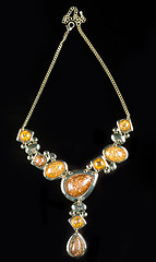 Image showing luxury yellow necklace on black stand