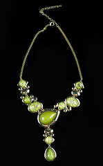 Image showing luxury green necklace on black stand