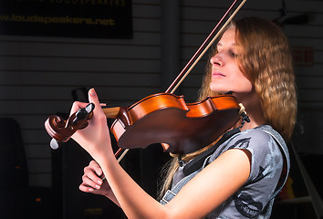 Image showing Attractive woman plays on violin