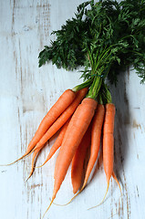 Image showing Bunch of fresh carrots with green leaves