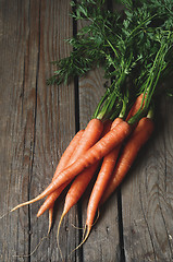 Image showing Bunch of fresh carrots with green leaves