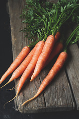 Image showing Bunch of fresh carrots with green leaves