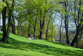 Image showing Young people relaxing in the park on the grass 