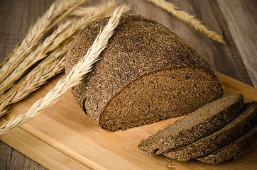 Image showing Black homemade bread and rye cones, close-up 